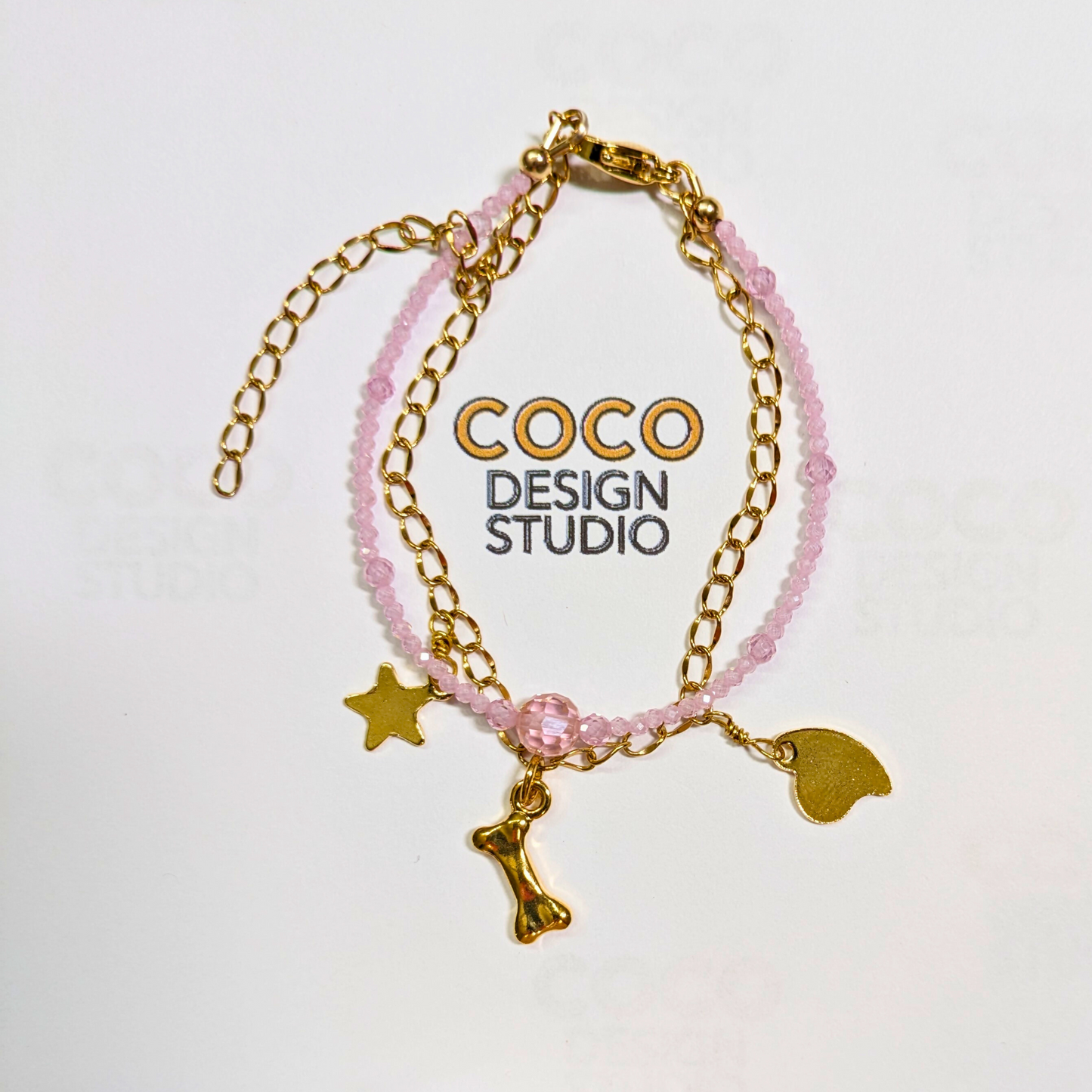 Whimsical Harmony Duo Bracelet: Faceted Pink Zirconia Double Strand with Stainless Steel Chain and Multi Charms